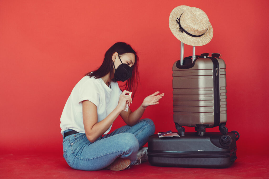  stylish girl posing with travel equipment red wall use some travel hacks