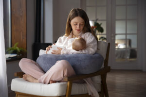 A new mom gearing up for breastfeeding to her baby in a comfortable setting, showcasing a nurturing bond and essential breastfeeding techniques.